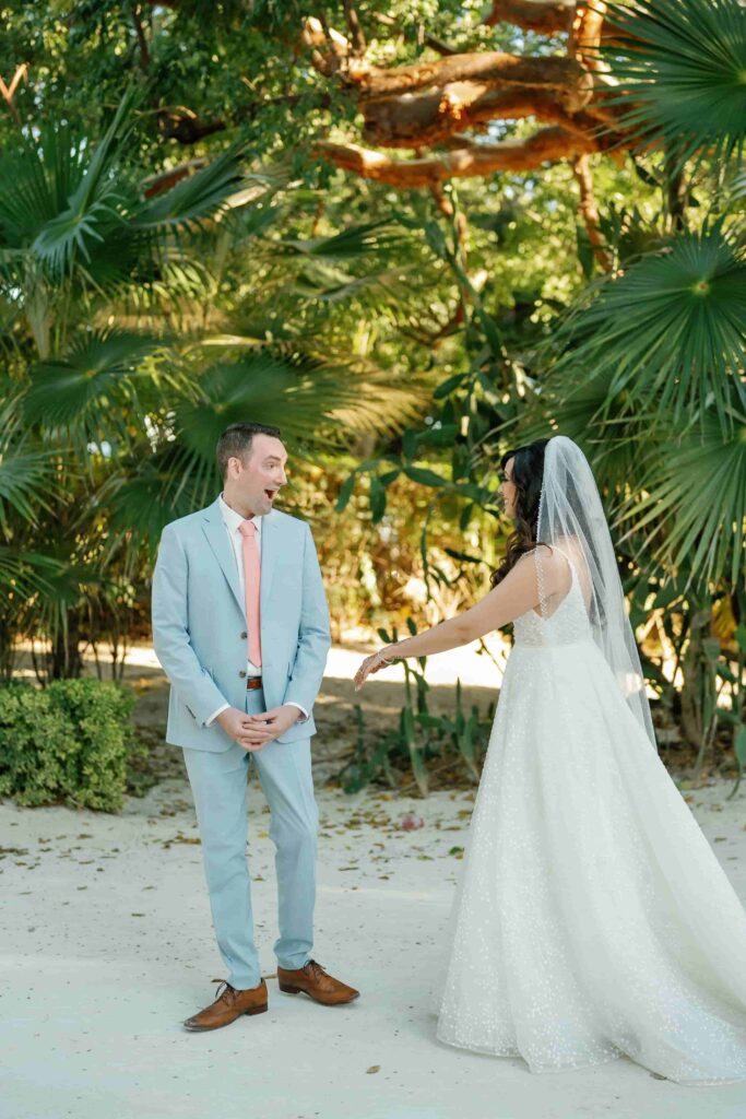 Robinson standing with joy and emotion as her bride walks toward her during the wedding ceremony.