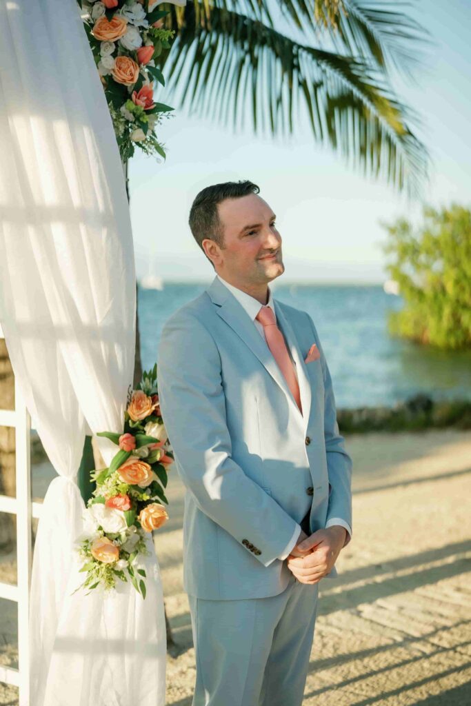 Robinson standing and eagerly looking at her bride with anticipation before the wedding ceremony.