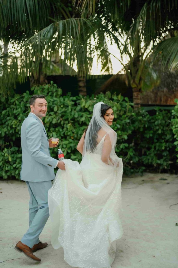 Robinson walking with her dress lifted slightly in one hand, looking back over her shoulder cheerfully at the camera.