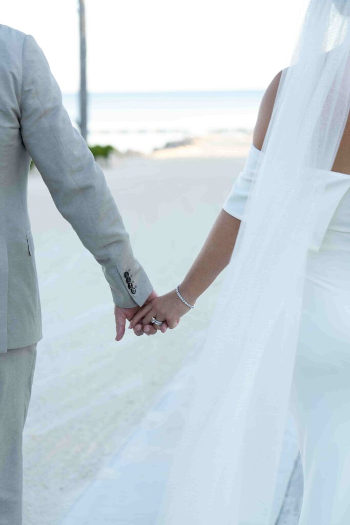 Alissa and Rob holding each other hand and walking towards beach